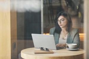 Young Businesswoman Working in Cafe Window